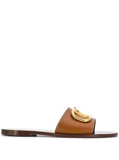 Brow VLogo-plaque slide sandals from Valentino featuring brown, calf leather, VLogo Signature, branded insole, open toe, slip-on style and flat leather sole. Valentino Slides, Chloe Sandals, Valentino Garavani Shoes, Heels Stilettos, Slides Women, Boot Pumps, Gucci Mules, Designer Sandals, Leather Slides