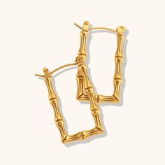 Be on-trend and fashion-forward with our 18K Rectangular Bamboo Hoops! These stylish earrings feature a trendy bamboo texture on rectangular hoops, crafted with non-tarnishing surgical stainless steel and a luxurious 18K PVD gold finish. Hypoallergenic and durable, these hoops make a statement without compromising comfort. Thin and lightweight. Latest Earrings Design, Pearl Gold Earrings, Custom Jewelry Packaging, Monstera Earrings, Crystal Ear Cuff, Bamboo Texture, Stylish Earrings, Gold Pearl Earrings, Stylish Earring