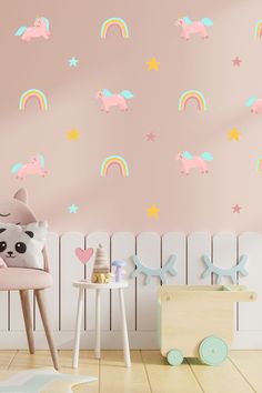 a child's room with pink walls and rainbow wall decals