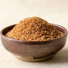 a bowl filled with brown sugar on top of a table