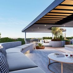 an outdoor living area with couches and tables