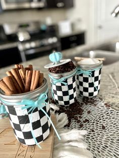 three jars filled with cinnamon sticks on top of a counter