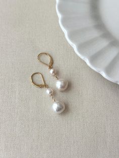 Never underestimate the power of a simple pearl drop earring! These double baroque pearl earrings look as beautiful on your special day as they do glamming up any casual outfit. They are sure to become a favorite go to accessory! * Natural 6mm and 10mm off-round white Baroque Pearls * 14K Gold Filled or 925 Sterling Silver 17mm Leverback clasp * 1.5 inch length * Made with all hypoallergenic materials 🤍 *Please note for the health and safety of my customers, and to uphold the highest quality standards - these earrings are final sale - please dm me with any questions prior to purchase 😊 ✨ Shop all Pearl earrings here!: https://etsy.me/3Xiy4c5 GET TO KNOW MAGBEE JEWELRY! ✨  🤍 All MagBee pieces are safe for sensitive skin and made with hypoallergenic Gold Filled or 925 Sterling Silver. 🤍 Cheap Dangle Earrings With Pearl Charm, Everyday Pearl White Drop Earrings, Pearl White Drop Earrings For Everyday Wear, Classic Adjustable Drop Pearl Earrings, Classic Handmade Pearl Earrings, Classic Long Drop Pearl Earrings With Matching Pair, Pearl White Teardrop Earrings For Everyday, Everyday Pearl White Teardrop Earrings, Pearl White Dangle Earrings For Everyday