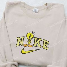 Introducing the Tweety x Nike Cartoon Embroidered Sweatshirt, a perfect blend of nostalgia and style. This sweatshirt features the beloved Tweety Bird character, beautifully embroidered on the front, adding a playful touch to your wardrobe. Made with premium quality materials, it offers utmost comfort and durability. Whether you’re lounging at home or heading out, this [...] Nike Christmas, Nike Cartoon, Nike Inspired, Mirabel Madrigal, Walt Disney Characters, Best Family Gifts, Embroidered Shirts, Cartoon Shirts, Cartoon Christmas