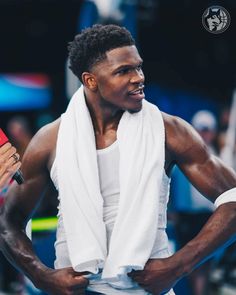 a male tennis player in a white towel