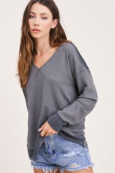 There is no such thing as too many basic tops in one closet! Its absolutely perfect for all the layering or even cute enough to sport on its own. You just can't go wrong with a simple waffle top, and with the v neckline and contrasted edges//stitching, you’ll be grabbing for this one all. Season. Long! Pair the Kacey Top with some distressed denim, a flannel or shacket, some booties and top it off with an wide brimmed hat to tie your outfit together! The deets! : true to size relaxed fit v neck Gray Ribbed V-neck Top, Trendy Waffle Knit Top For Loungewear, Casual Ribbed Loungewear Tops, Ribbed V-neck Top For Layering, Sporty Ribbed Tops For Layering, V-neck Loungewear Top With Ribbed Cuffs, V-neck Top With Ribbed Cuffs For Loungewear, Casual Waffle Knit Tops For Layering, Everyday Ribbed V-neck Top