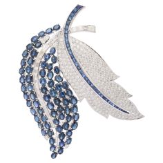 23.97 CTW Statement Blue Sapphire Diamond Feather Brooch Gift in 18K White Gold which is a fusion of surrealism and pop-art, designed to make a bold statement. Crafted with love and attention to detail, this features 23.97 carats of blue sapphire and 1.61 carats of diamond. Sapphire stimulates concentration and reduces stress. This brooch is truly a must have accessory to elevate your wardrobe with its timeless beauty and versatility which makes you stand out of the crowd. This is a perfect Uniq Luxury Sapphire Brooches For Formal Occasions, Luxury Sapphire Brooches For Formal Events, Groom To Be, Feather Brooch, Diamond Ribbon, Gemstone Brooch, Contemporary Jewelry Design, Diamond Bows, Wedding Brooch