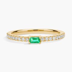 Harmoniously pieced together, this ring features a verdantly-hued baguette-cut emerald center stone on a 14k yellow gold band sparkling with pave-set diamonds for a timeless design. Due to this ring's delicate nature, we do not recommend for daily wear and are unable to resize or repair. Classic Green Diamond Stackable Ring, Green Emerald Cut Stackable Emerald Ring, Classic Green Stackable Diamond Ring, Green Baguette Cut Stackable Rings, Emerald Cut Green Diamond Ring In 14k Gold, Classic Green Baguette Cut Diamond Ring, Baguette Cut Emerald Ring For May Birthstone, Green Emerald Stackable Ring With Baguette Cut, Stackable Emerald Cut Green Diamond Ring