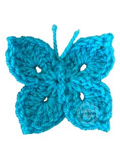 a blue crocheted butterfly on a white background