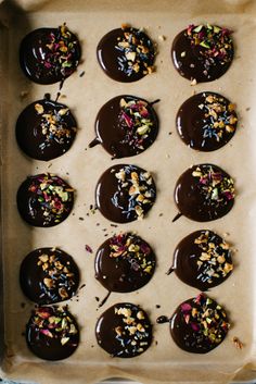 chocolate covered donuts with sprinkles and confetti on top in a pan