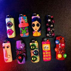 six cell phones are lined up in a row on the floor, all decorated with different designs and colors