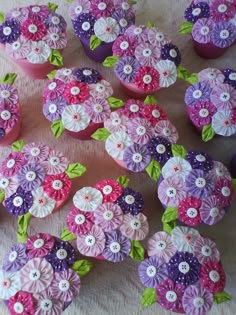 cupcakes decorated with pink and purple flowers