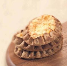 three small pies sitting on top of a wooden table