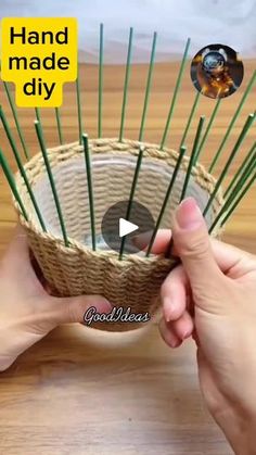 a person holding a basket with green sticks in it and the words hand made diy