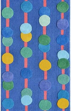 a blue rug with multi colored circles on it