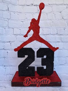 a red and black air jordan cake topper with the number twenty two on it