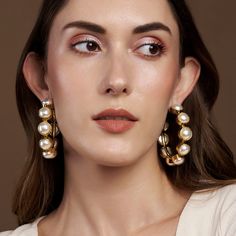 The combination of the gorgeous yellow gold and pearls make you feel like a Greek Goddess. Hoops are something a girl can never have enough off and we personally love! Circumference: 6 cm Total Weight: Weight: 62 grams Material: Pearls, Brass, 18K Yellow Gold Plating Fastening: Butterfly back Gold Hoop Earrings With Pearl Chain For Wedding, Yellow Gold Metal Pearl Earrings, Wedding Gold Hoop Earrings With Pearl Chain, Party Pearl Charm Hoop Earrings, Party Hoop Earrings With Pearl Charm, Gold Pearl Hoop Earrings For Anniversary, Pearl Embellished Hoop Earrings For Wedding, Gold Feminine Pearl Earrings For Party, Feminine Gold Pearl Earrings For Party