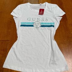 Guess Logo Tee Shirts Is Brand New With The Tags Size : S Color : White Made In Bangladesh Cotton Logo Short Sleeve Tops, Cotton Logo Top With Short Sleeves, Short Sleeve Cotton Top With Logo, Fitted Sporty Tops With Logo, Sporty Fitted Tops With Logo, Spring Cotton Tops With Logo, Spring Cotton Top With Logo, Logo Fitted Crew Neck Top, Fitted Logo Top With Short Sleeves