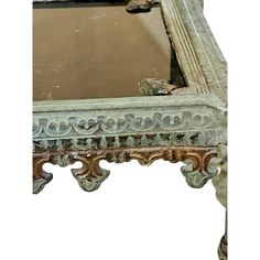 an old wooden table with a mirror on it's top and some paint peeling off the edge