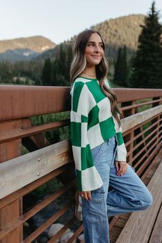 Get ready to rock the back to school season with THE KYAH LONG SLEEVE CHECKERED TOP IN GREEN! This cute top features a fun checkered print, perfect for adding some playful style to your wardrobe. The long sleeves and soft material make it a cozy choice for cooler days. Don't miss out on this must-have piece! Paired with THE JUST BLACK DENIM LYNN STRETCH CARGO PANTS IN MEDIUM DENIM and THE CASUAL SNEAKERS IN GREY Long Sleeves Checkered pattern Round neck 70% Viscose, 30% Polyester Fits true to si Retro Green Tops For Fall, Preppy Green Tops For Fall, Plaid Tops For School In Fall, Green School Tops For Fall, Trendy Tops For School In Fall, Green Fall School Top, Green Preppy Tops For Fall, Green Preppy Cotton Tops, Long Sleeve Checkered Outfit