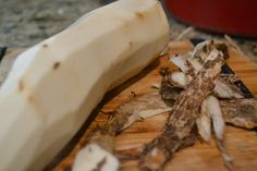 a close up of a banana on a cutting board with other foods in the background