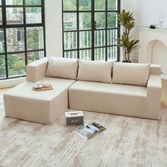 a living room with large windows and a sectional couch