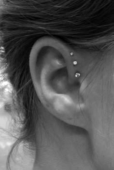 a woman's ear is shown with the words triple forward helix on it