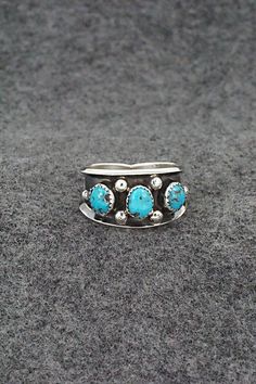 This turquoise and sterling silver ring was made by Navajo silversmith Paul Largo. The inside is stamped sterling.Size: 10Length: 1/2"Free shipping on all orders! We ship with USPS and always include tracking. All orders ship within a day of payment.Returns are accepted up to 30 days after you receive your order. Just send us a message. Our shop offers cash back or store credit. The item must be returned in new condition. Southwestern Sterling Silver Turquoise Ring For Anniversary, Western Style Blue Sterling Silver Ring, Southwestern Turquoise Open Ring In Sterling Silver, Southwestern Style Turquoise Open Ring In Sterling Silver, Southwestern Sterling Silver Turquoise Open Ring, Western Style Untreated Sterling Silver Rings, Southwestern Untreated Turquoise Sterling Silver Ring, Untreated Southwestern Turquoise Sterling Silver Ring, Navajo Rings