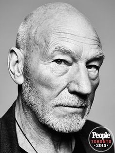 an older man with white hair and beard wearing a black shirt is looking at the camera