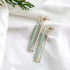 "Elevate your look with our Handmade Rectangle Hoop Gold & Mint earrings. Crafted with a luxurious gold frame and delicate mint green seed beads, these earrings offer understated elegance and sophistication. * 14k Gold Filled Wire * Earrings measure 1.75\" long * Mint Green Seed Beads * Polished to a High Shine * Sent in a Ribboned Gift Box with Polishing Cloth * Handmade in Montana   ----- OUR MATERIALS -----  *STERLING SILVER - Experience the elegance of Sterling Silver, a metal that combines versatility with a sophisticated look. This durable and lightweight alloy is perfect for everyday wear, offering a timeless appeal. Our jewelry is crafted from .925 certified sterling silver, guaranteeing its authenticity and longevity. *14K GOLD FILLED - Gold-filled pieces have the same appearance Rectangle Hoop Earrings, Woven Jewelry, Mint Earrings, Hardware Jewelry, Essential Oil Jewelry, Jewelry Pliers, Mini Earrings, Rectangle Earrings, Skincare Gift Set