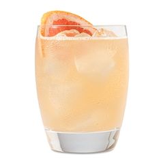 a glass filled with orange juice and garnished with an orange slice on the rim