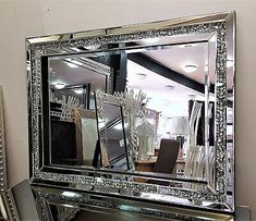 a large mirror sitting on top of a table