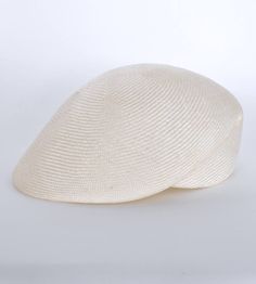 "\"Lou\" is a light cap with a sophisticated lateral fold and a small shield. The slider cap made of the unbleached straw of the Agave is pleasantly air-permeable and very light. The woven type Parasisol results in a fine \"herringbone\" pattern. A hat band sewn in by hand with an invisible stitch ensures a perfect fit and a noble look. I manufacture the cap in the colour \"nature\". The peaked cap can be combined to elegant and sporty outfits. The design is timelessly beautiful, equally perfect White Flat Cap For The Beach, White Flat Cap For Beach, Linen Flat Cap For Summer, Summer Linen Flat Cap, Cream Sinamay Hat For Summer, Beige Sinamay Hat For Summer, Summer Beige Sinamay Hat, Eco Fashion Design, Invisible Stitch