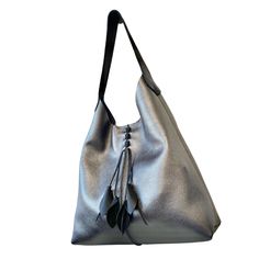 "If you'd like the bag in a different color, please choose an option from the listing below www.etsy.com/listing/1038913311 Add lining to any of our bags https://www.etsy.com/listing/891051352 Metallic, slouchy leather hobo bag with black wide strap and front leaves. Measurements- 18\" wide x 16\" high on the side 15\" strap drop, can be worn as a crossbody bag. Our Full grain leather is the highest quality grade of leather available that beautifies with use and age and will last a lifetime. It Large Leather Bag, Perfect Purse, Leather Industry, Work And Travel, Large Shoulder Bags, Leather Hobo Bag, Laptop Pocket, Overnight Bag, Leather Hobo