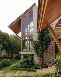 the house is surrounded by greenery and trees