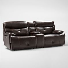 a brown leather reclining sofa sitting on top of a white floor