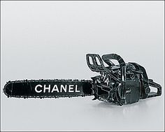 a black and white photo of a chainsaw with the word chanel on it