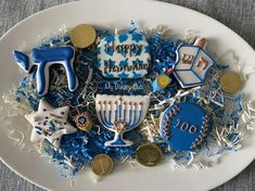 a white plate topped with lots of decorated cookies