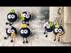 four crocheted black sheeps with yellow flowers on their heads are hanging from a keychain