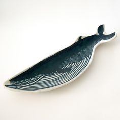 a blue and white whale shaped dish sitting on top of a table