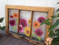 three windows with flowers painted on them