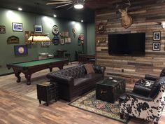 a living room filled with furniture and a flat screen tv mounted on the wall next to a pool table