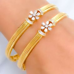 This exquisite set of 18k gold bangles, with a total weight of 34.8 grams, features an elegant floral design adorned with dazzling diamonds. The yellow gold finish enhances their luxurious appeal, making them perfect for any special occasion. Each bangle is set with a total diamond weight of 3.18 carats, featuring F-G color and VS quality diamonds in round, pear, and baguette shapes. With a bangle size of 2.7 and an opening diameter of 2.45 inches, these pieces offer both elegance and comfort. I Diamond Bangle In Yellow Gold With Intricate Design, Diamond Bangle With Intricate Design In Yellow Gold, Dazzling Yellow Gold Bangle For Anniversary, Yellow Gold Diamond Bangle With Intricate Design, Elegant 22k Gold Wedding Bangle, Elegant Gold American Diamond Bracelets, Elegant American Diamond Bangle For Anniversary, Dazzling Yellow Gold Cubic Zirconia Bangle, Gold Plated Diamond Bangle For Wedding