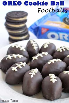 chocolate covered footballs on a plate with white frosting