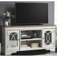 an entertainment center with a flat screen tv on top