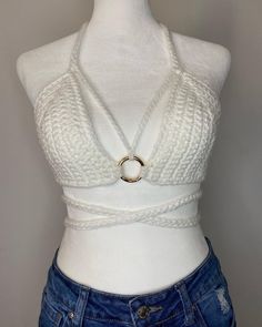 a mannequin wearing a white top with a ring on it's neck