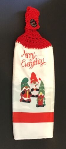 a red and white christmas bag with two gnomes on it's side, the tag says merry everything