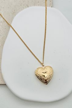 Get a heart-shaped locket necklace with a smooth finish for a vintage-inspired look. Keep your loved ones close to your heart (literally) with this charming accessory. 16" Chain + 3" Extender Charm: 1" x 1" Lobster Clasp closure Brass Shiny Gold Plating Vintage Locket Necklace, Locket Necklace Vintage, Jewelry Wishlist, Red Heart Necklace, Necklace Locket, Vintage Locket, Heart Locket Necklace, Vintage Lockets, Gold Locket