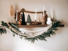 a mantle with candles and garland on it