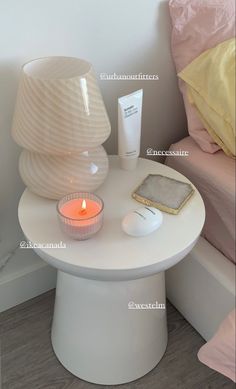 a white table with a candle and some items on it